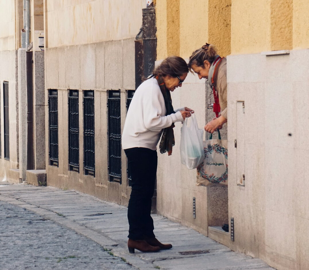 elderly woman smiling with neighbors