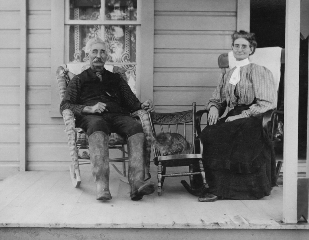 elderly neighbors chatting on porch